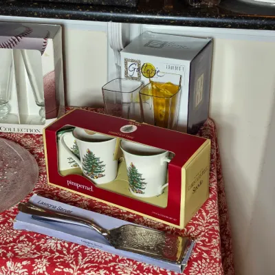Assortment of holiday and entertaining items, including a boxed Spode Christmas Tree mug set, a silver-plated lasagna server, and various...