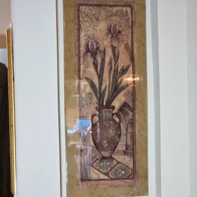 Vertical framed art print depicting irises in an ornate classical vase, finished with a high-gloss protective coating.