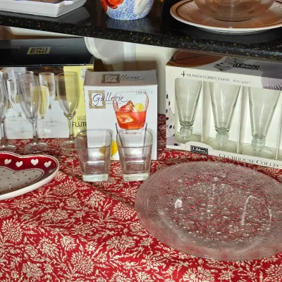 Assorted glassware collection including a Libbey Clubhouse Collection set, Gallerie tumblers, champagne flutes, a heart-shaped ceramic...