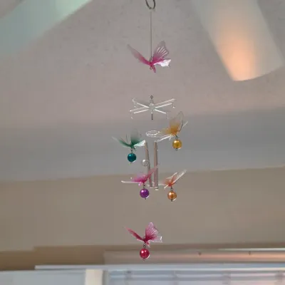 Decorative butterfly wind chime featuring translucent, colorful acrylic butterflies and hanging beads.