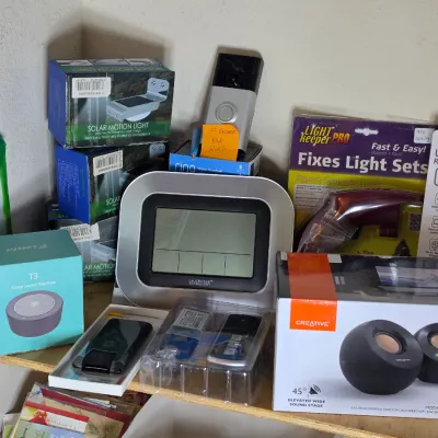 Assortment of home electronics and accessories, including a La Crosse Technology weather station, Creative Pebble desktop speakers, a...