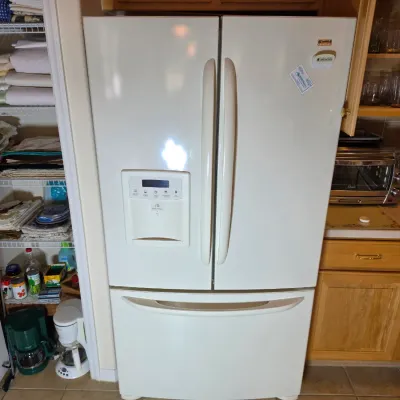 Kenmore Elite white French door refrigerator with a bottom freezer drawer and an external water and ice dispenser.