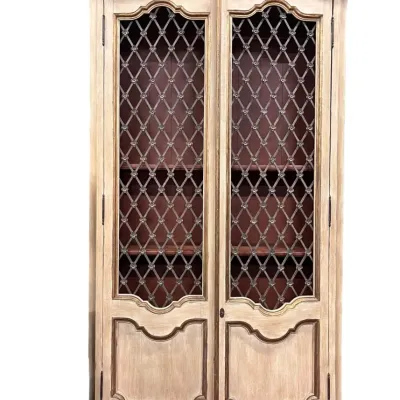 French Provincial style armoire featuring a distressed cream finish, gold-painted trim, and two doors with decorative wire mesh inserts...