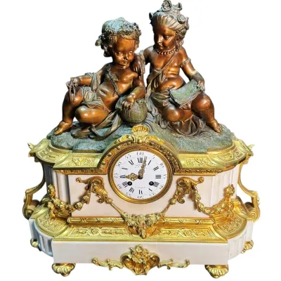 Antique French Louis XVI style mantel clock featuring a white marble base with ornate gilt bronze mounts, topped with a bronze sculpture...