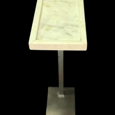 Modern drink table featuring a rectangular white marble top with a raised border, supported by a sleek brushed metal pedestal and base.
