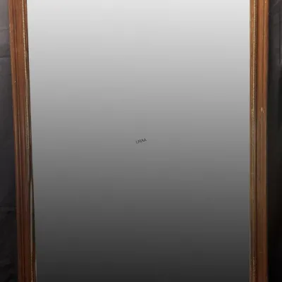 Large rectangular wall mirror featuring a classic wooden frame with a beaded inner border.