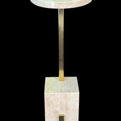 Postmodern travertine and brass pedestal drink table, featuring a round stone top supported by a polished brass stem on a heavy block base.