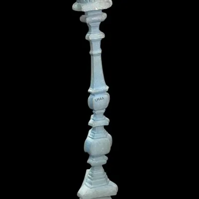 Antique carved wooden pricket candlestick with a distressed light blue painted finish, featuring a baluster-style shaft and a tripod base.