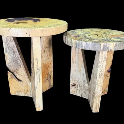 Pair of rustic live-edge spalted maple side tables featuring thick round tops and interlocking geometric bases.