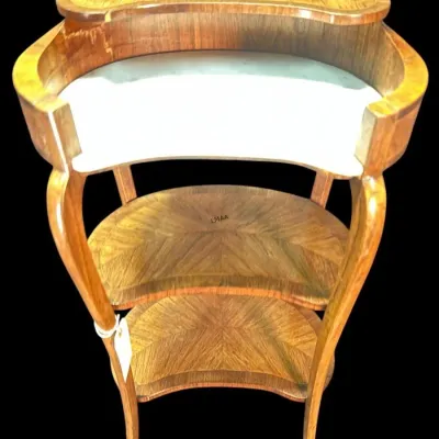 French-style kidney-shaped bar cart or side table featuring a white marble top, inlaid wood shelves, and curved legs.