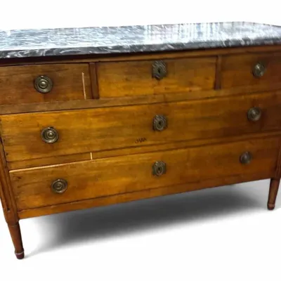 Antique French Louis XVI-style commode featuring a grey-veined marble top, three drawers with brass ring pulls and escutcheons, and...
