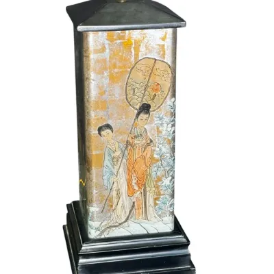 Vintage Asian-style table lamp featuring a rectangular body decorated with a hand-painted scene of two figures on a gold and silver leaf...