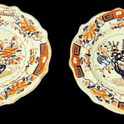 Pair of antique Imari-style ironstone plates with scalloped rims, featuring a traditional cobalt blue and rust-orange floral and pagoda...