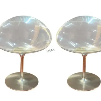 Set of four mid-century modern Erwine and Estelle Laverne "Champagne" chairs, featuring clear lucite shell seats on aluminum...
