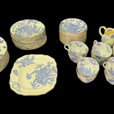 Booth & Sons "Dragon" pattern semi-porcelain dinnerware set, featuring blue dragon motifs on a cream background with gold...