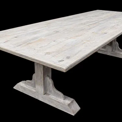 Rustic trestle-style dining table featuring a weathered gray wash finish and a planked wood top.