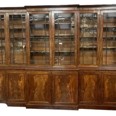 Large mahogany breakfront bookcase featuring six leaded glass doors on the upper section and six flame mahogany cabinet doors below.
