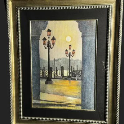 Framed colored pencil or pastel drawing depicting a Venetian street scene with ornate lamp posts, housed in a double-matted gold-finished...