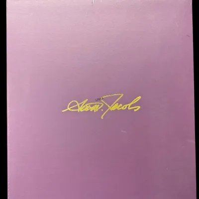 Marc Jacobs lavender shoe box featuring a gold-embossed signature logo on the lid.