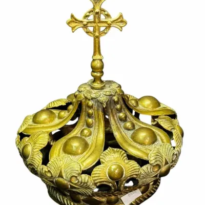Antique brass crown-shaped reliquary dome or architectural finial, featuring ornate leaf motifs and topped with a Celtic-style cross.