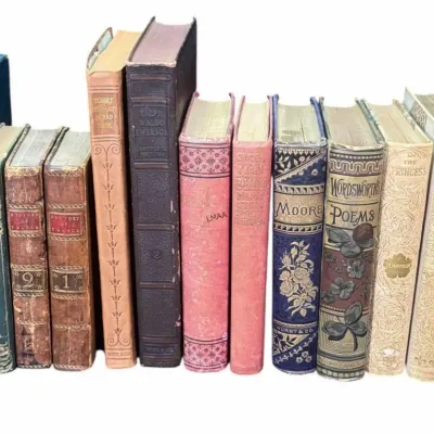 Collection of antique and vintage hardcover books, featuring decorative embossed spines, poetry collections, and classic literature from...