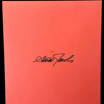 Marc Jacobs signature logo printed in black on a solid red background.