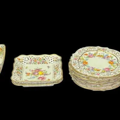 Schumann Arzberg Dresden-style reticulated porcelain serving pieces, including a large bowl, small square dishes, a stack of plates, and...
