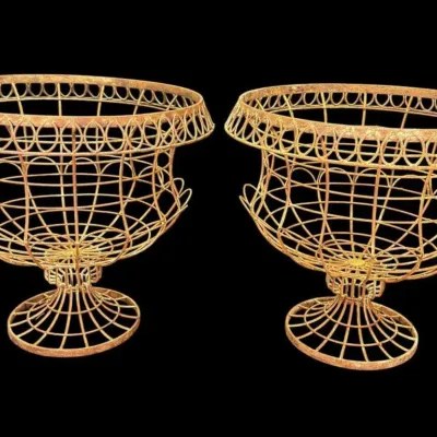 Pair of vintage French-style wirework garden urn planters with a rusted patina finish.