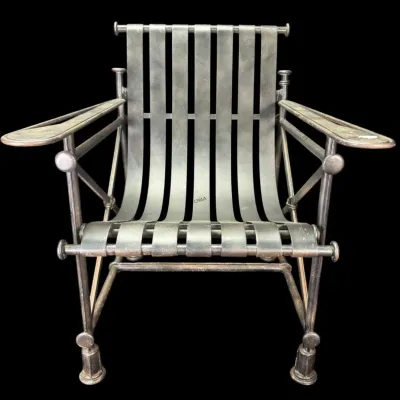 Vintage Cleo Baldon for Galaxie patio armchair, featuring a black wrought iron frame with wide strap metal seating and flat armrests.