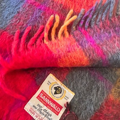 Vintage Sannwald mohair and virgin wool blanket made in Austria, featuring a vibrant plaid pattern in pink, orange, and grey with fringed...