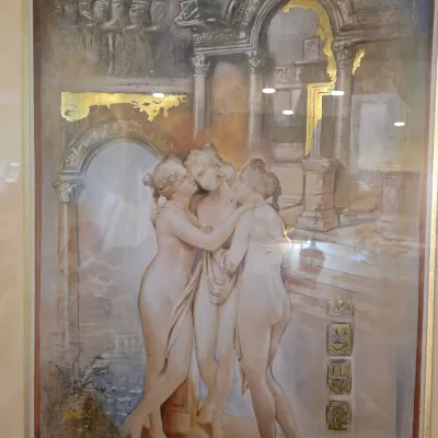 Framed mixed media artwork depicting the Three Graces amidst classical ruins, featuring gold leaf accents and signed by the artist Joadcoro.
