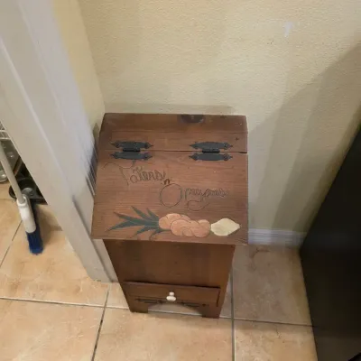 Rustic wooden potato and onion storage bin featuring hand-painted "Taters 'n Onyons" lettering and illustrations, with a...