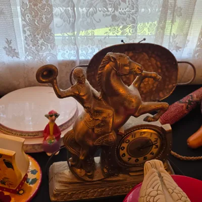 Vintage United Clock Corp. electric mantel clock featuring a bronze-finished metal cowboy riding a rearing horse, circa mid-20th century.