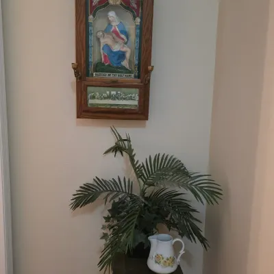 Vintage Catholic sick call shadow box crucifix cabinet in an oak frame, featuring a Pieta scene and a Last Supper depiction, shown...