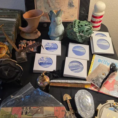 Assortment of vintage collectibles, including a silver-plated hand mirror and comb set, small blue-and-white maritime illustrations, a...