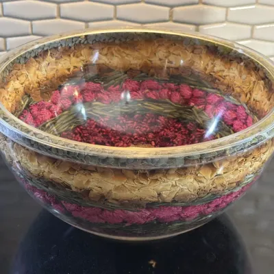Vintage double-walled acrylic salad bowl filled with dried botanicals, including pink clover blossoms and green leaves, in excellent...