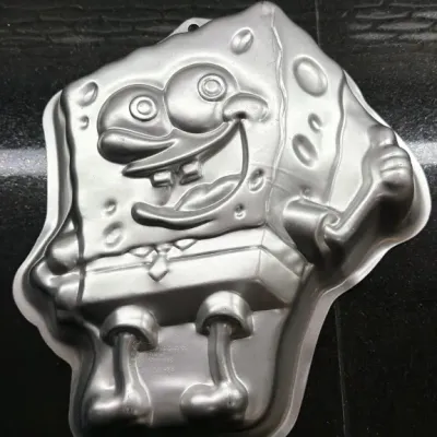 Vintage Wilton SpongeBob SquarePants aluminum cake pan, showing minor wear from use.