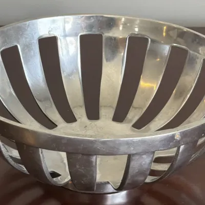 Modernist silver-plated or pewter fruit bowl featuring a slatted, openwork design with a polished finish.