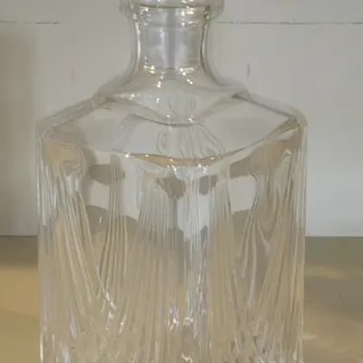 Vintage square cut glass decanter with a matching diamond-patterned stopper, featuring vertical and crisscross geometric cuts.