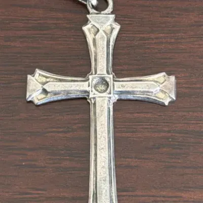 Sale Photo Thumbnail #287: Vintage sterling silver cross pendant featuring a flared, gothic-style design with a textured finish and a large bail.