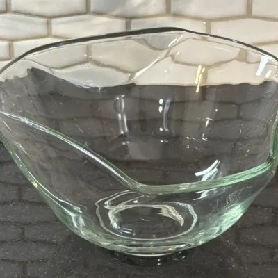 Vintage clear glass mixing bowl featuring a unique asymmetrical, organic rim design.