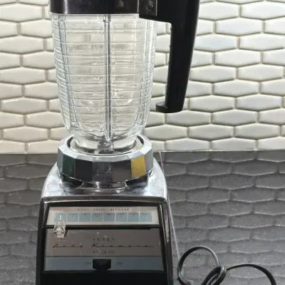 Vintage Sears Lady Kenmore 800 eight-speed blender with a chrome base and a ribbed glass pitcher.