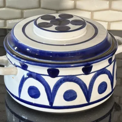 Vintage hand-painted ceramic covered casserole dish featuring a blue and white geometric pattern.