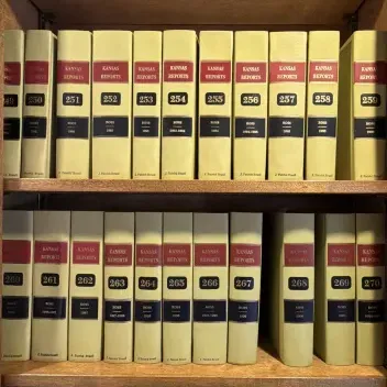 Sale Photo Thumbnail #121: A collection of vintage Kansas Reports law books, volumes 237 through 283, arranged on wooden bookshelves.