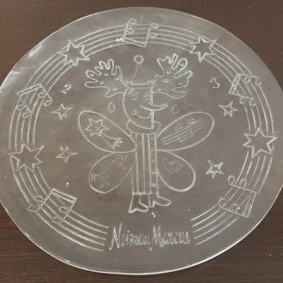 Vintage Neiman Marcus clear glass platter featuring an etched whimsical holiday character with moose antlers, stars, and musical notes.