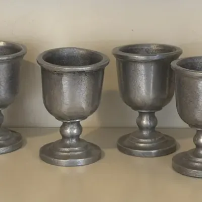 Set of six vintage pewter-style metal goblets with a textured, matte finish and baluster stems.