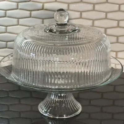 Vintage clear pressed glass pedestal cake stand with a matching ribbed dome lid, featuring a round ball finial.
