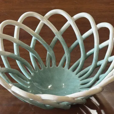 Vintage Italian ceramic woven basket bowl featuring a two-tone glaze that transitions from sage green at the base to white at the rim.