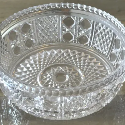 Vintage cut glass serving bowl featuring intricate geometric patterns and a scalloped rim.