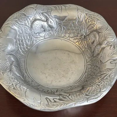 Arthur Court pewter-style aluminum serving bowl featuring an embossed woodland design with rabbits, acorns, and foliage.
